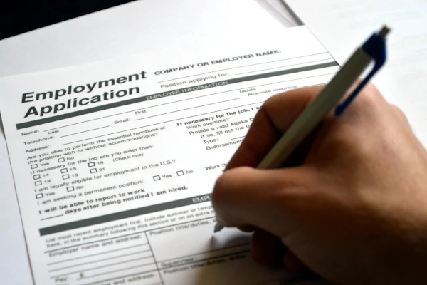 Person filling out an application form